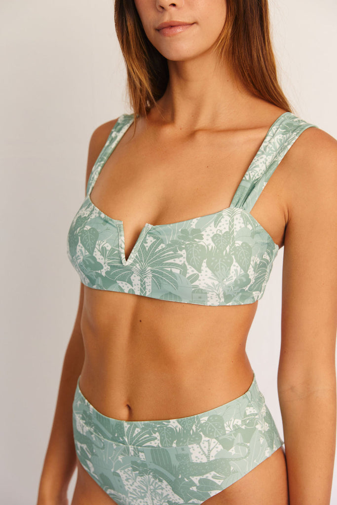 Green and white tropical printed bikini top with structured v neckline with thick straps and a metal clasp closure in the back