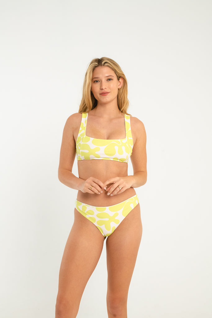 light blue and lime green abstract patterned bralette style reversible swim top with thick straps