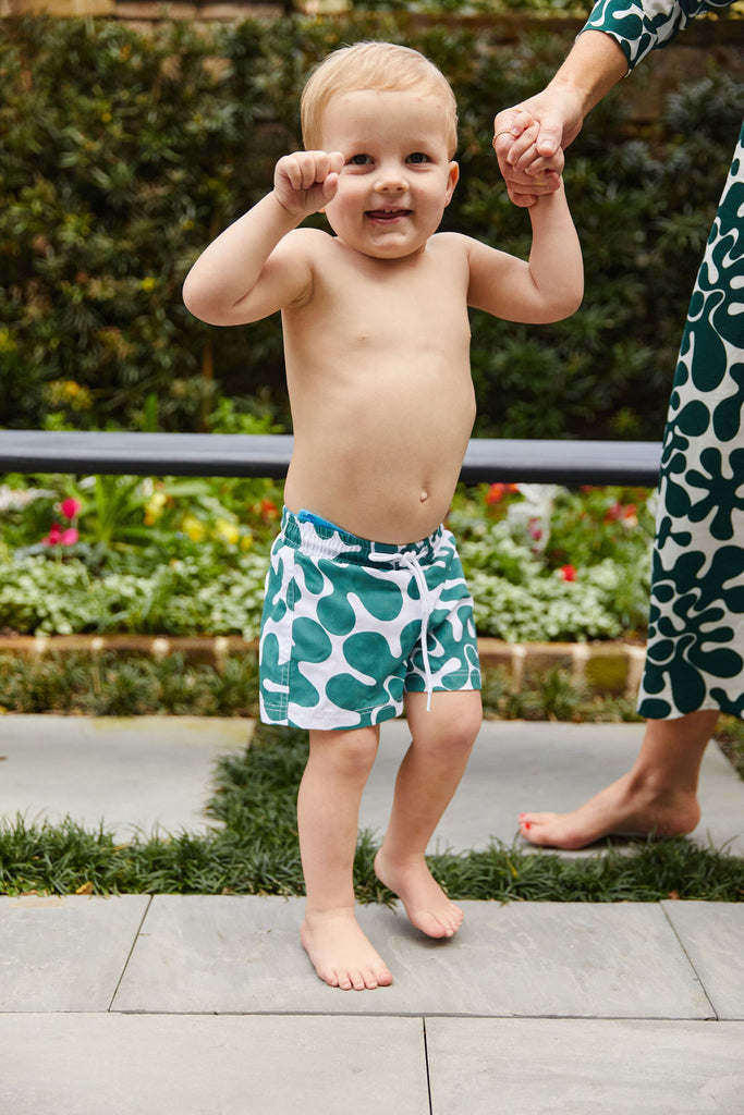 Green and White abstract printed boys boardshort with elastic waist and drawstring tie.
